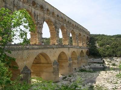 This is a photograph of a roman insula. aqueduct. bridge. coliseum.