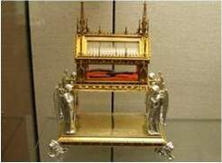 This is a photograph of the sandal reliquary of saint andrew. explain what a reliquary is as well as
