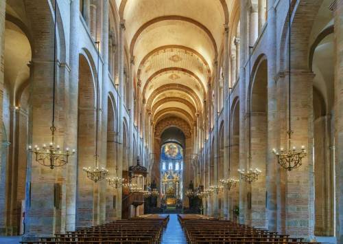 How did religion influence architectural design within the romanesque period?  identify three archit