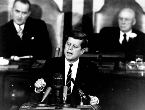 According to jfk what does the space race represent to the american public?