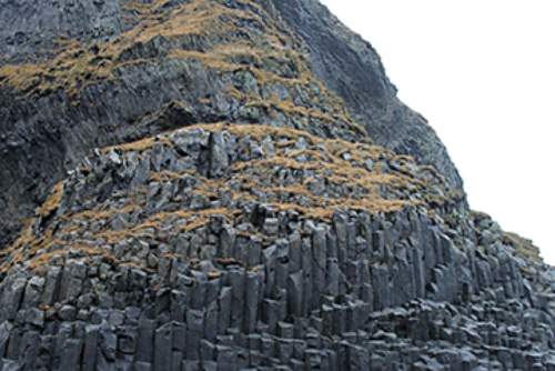 7. the photograph shows hexagonal basalt columns on a mountain that formed from a volca