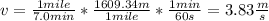 v=\frac{1mile}{7.0min}*\frac{1609.34m}{1mile}*\frac{1min}{60s}=3.83\frac{m}{s}