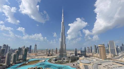 The fastest elevators in the Burj Khalifa can travel 330 feet in just 10 seconds. How far does the e