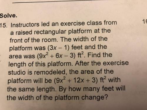 Instructors led an exercise class from a raised rectangular platform at the front of the room. The w