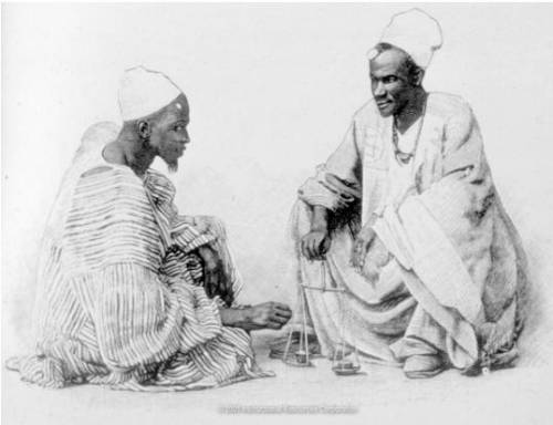 The image shows gold traders in Timbuktu using scales to weigh gold. Be sure to provide details and