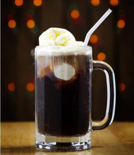 A glass of root beer with a scoop of ice cream floating on top and a straw sticking out.

Describe
