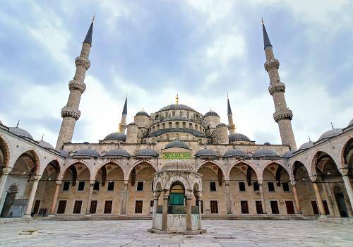 Study the image of the Blue Mosque at Istanbul carefully. Describe two elements of the mosque and e