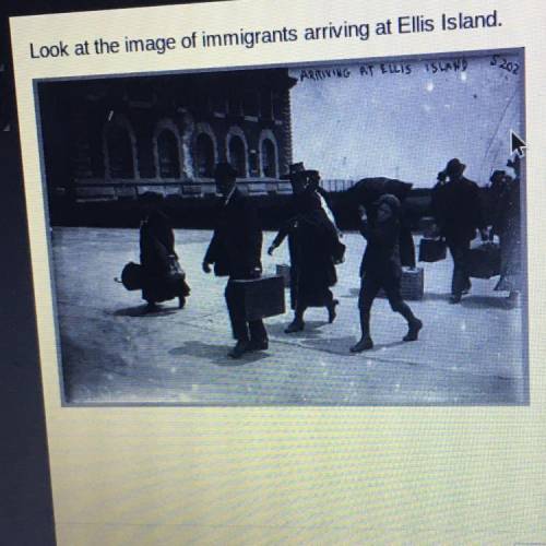 Look at the image of immigrants arriving at Ellis Island.

Which item of clothing was commonly wor