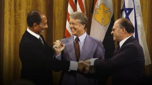 The historic photograph shown above is of former President Jimmy Carter, ushering a peace treaty wi