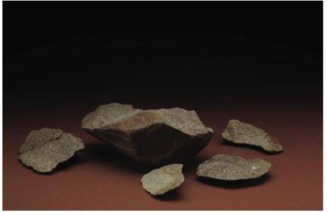 Which reason best explains how the use of stone tools, such as those shown in Source 2, by early hu