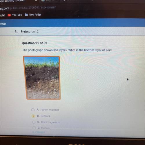The photograph shows soil layers. What is the bottom layer of soil?