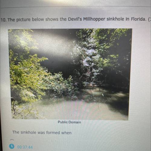The picture below shows the devils Millhopper sinkhole in Florida.

The sinkhole was formed when: