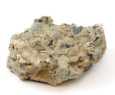 Light colored rock that contains small pieces of other types of rock.

What kind of rock is shown